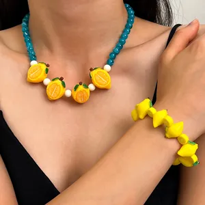 Detailed view of handmade yellow lemon necklace and bracelet jewelry set for women
