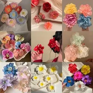 Detailed view of colorful fabric flower hair clips and scrunchies in various styles