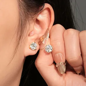 Primer plano de pendientes de moissanita de tres garras usados en la oreja