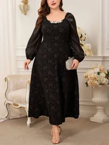 Plus-size black jacquard dress with square neckline, rhinestone trim, and sheer puff sleeves.