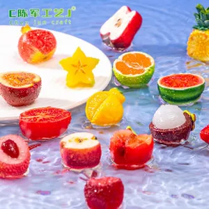 Detailed view of assorted miniature resin fruit figurines floating on water surface