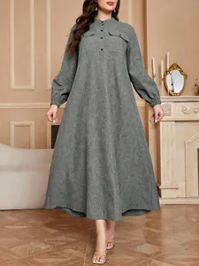 Full-length view of a grey A-line plus size dress with lantern sleeves and pockets