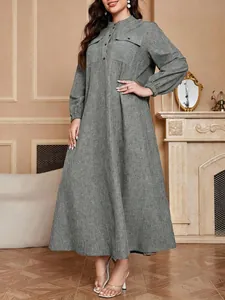Grey textured long sleeve maxi dress with button details in a classic interior setting