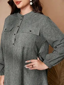 Close-up of plus size grey linen-textured dress with stand collar and lantern sleeves