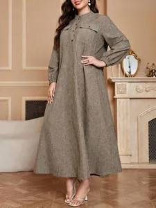 Elegant plus-size maxi dress with lantern sleeves and textured fabric in autumn tones