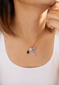 Detail of 18k gold plated stainless steel teardrop necklace with colorful zircon pendants