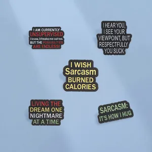 Close-up of five sarcastic quote enamel pins with colorful text on blue background