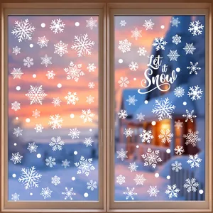 Detail of white snowflake window clings with 'Let it Snow' text on glass pane