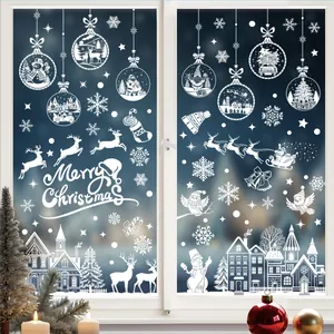 Detailed view of white silhouette Christmas window stickers applied to a glass surface.