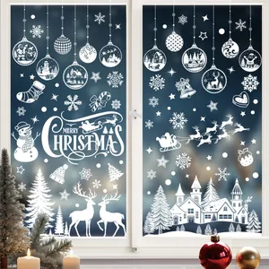 White silhouette Christmas window stickers featuring festive winter scenes on glass