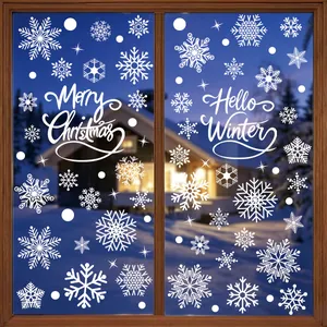 Detailed view of white snowflake static window stickers on a window with a snowy background