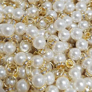 Close-up detail of high-gloss ABS pearl pendants featuring golden rhinestone-encrusted caps