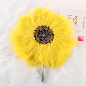 Decorative yellow feather fan with sunflower shape and black lace floral center