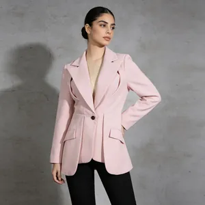 Detailed view of pink tailored blazer with unique waist pleats and single button.