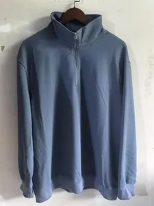 Blue men's waffle knit quarter-zip sweatshirt on a hanger with stand-up collar