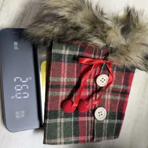 Close-up of a festive red plaid Christmas wine bottle cover with faux fur collar, 26g