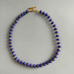 Close-up of blue and yellow natural stone abacus bead necklace with T-bar clasp