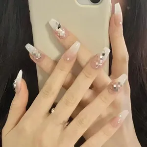 Handmade long coffin press-on nails featuring white ombre and cross rhinestone accents