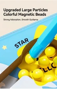 Close-up of blue magnetic pen attracting large yellow beads in a children maze toy