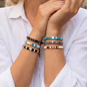 Close-up of bohemian colorful enameled copper elastic bracelets on model