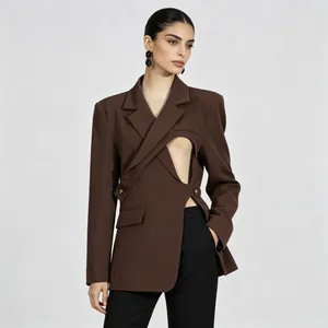 Detail view of a brown tailored blazer featuring a unique waist cutout and wrap design