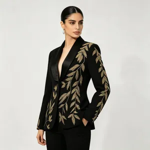 Elegant detail of premium black blazer featuring intricate gold leaf embroidery design