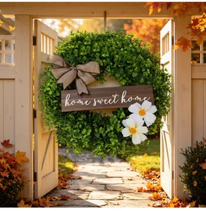 Lush green boxwood wreath with burlap bow and home sweet home wooden sign