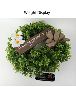 Artificial Christmas wreath with 'Home Sweet Home' wooden sign, weight shown at 210.0g