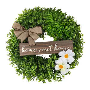 Decorative artificial green wreath with burlap bow and home sweet home wooden plaque