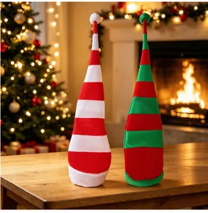 Detail view of red and green striped velvet Christmas tall hats in a cozy room
