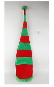 Long red and green striped velvet Christmas elf hat shown hanging against a white wall.