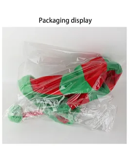 Close-up detail of the red and green striped Christmas elf hat in clear plastic packaging