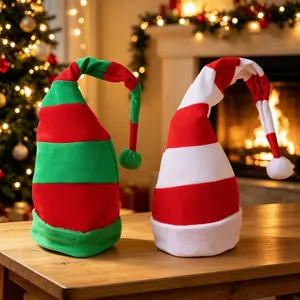 Long striped velvet Christmas hats with posable wire on cozy fireplace and tree background