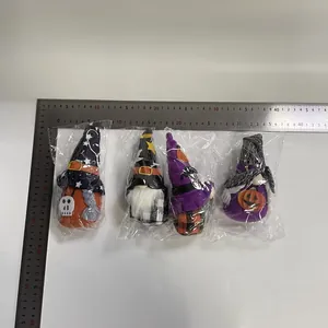 Macro detail showing four Halloween faceless gnome plushies size with metal ruler