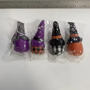 Detailed view of four colorful Halloween plush gnome ornaments in individual packaging with size ruler