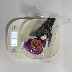 Halloween gnome plush toy ornament weighing 64.4 grams on a digital scale for weight detail