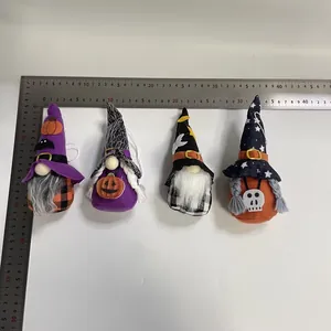 Detailed view of four Halloween gnome doll hanging ornaments with a ruler for size reference.