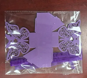 Purple laser-cut butterfly candy box with matching ribbon shown in clear packaging