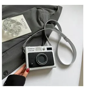 Retro silver camera-shaped box bag with stylish crossbody strap for women.