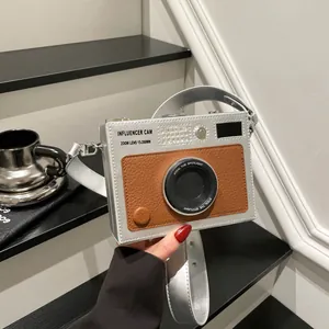 Vintage camera-shaped crossbody box bag with silver and brown faux leather finish.