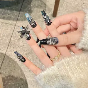 Macro detail of handmade luxury press-on nails with dark cat-eye glitter and zircons.