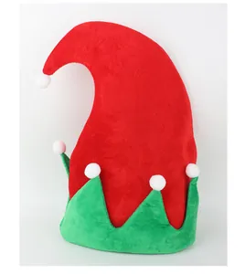 Detail of festive red and green elf Christmas hat with white pom-poms decoration