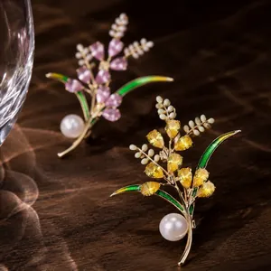 Close-up of elegant wheat ear brooches with sparkling crystals and lustrous pearls