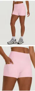 Close-up of high-waisted pink yoga shorts featuring a functional side pocket for phone storage.