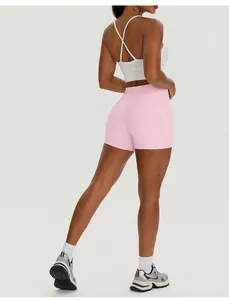 Back view detail of high-waisted pink yoga shorts with pockets for women's gym workout
