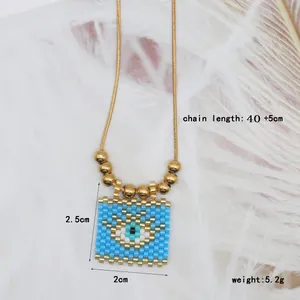Detailed view of bohemian blue evil eye seed bead pendant necklace with gold beads