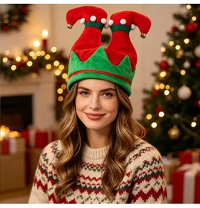 Cheerful woman wearing a red and green Christmas elf legs hat with bells in festive setting
