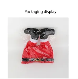 Detail view of a funny Christmas elf leg hat decoration in clear packaging bag