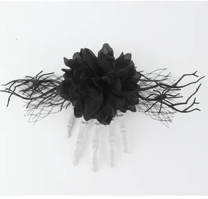 Detailed close-up of a Gothic Halloween hair clip featuring a black flower and skeleton hand