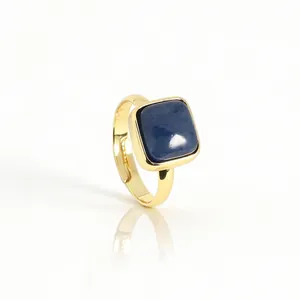 Close-up of adjustable gold ring featuring a minimalist square blue natural gemstone